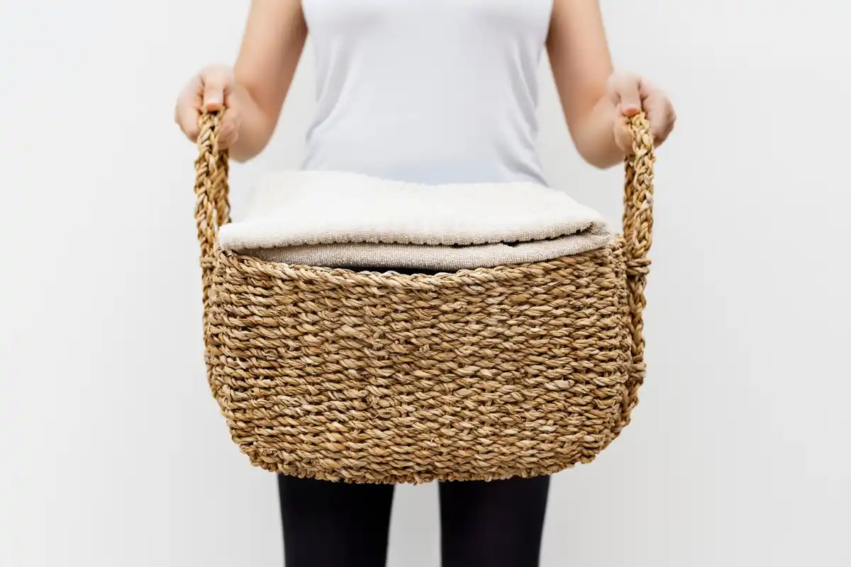 emptying a laundry basket into washing machine, chaotic home scene