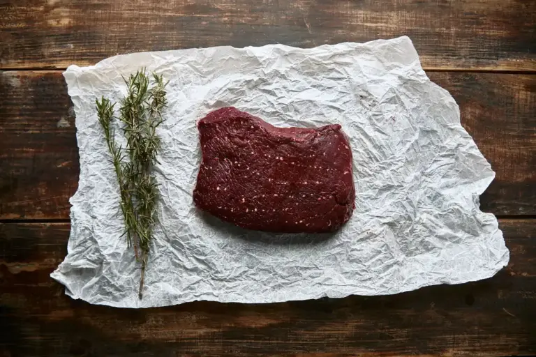 raw beef steak with ice cubes closeup