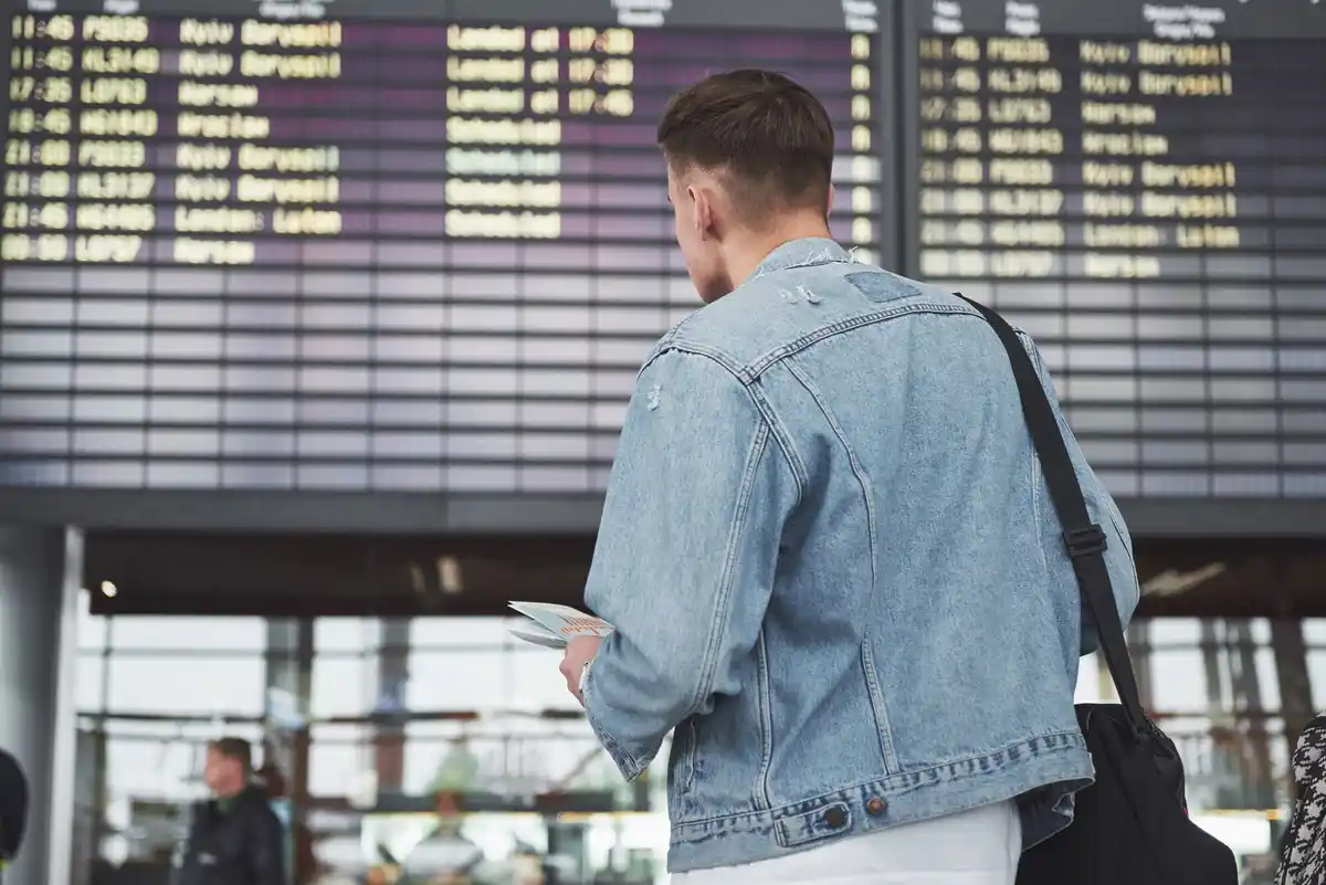 family looking at airport flight board netherlands