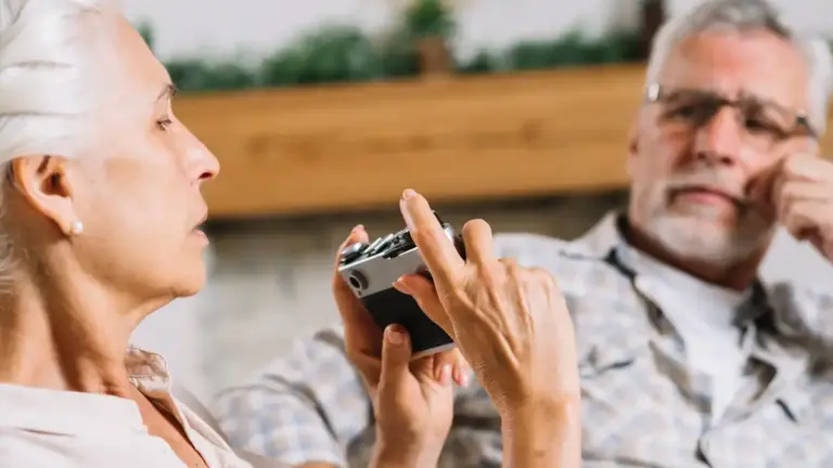 senior using bluetooth key finder at home