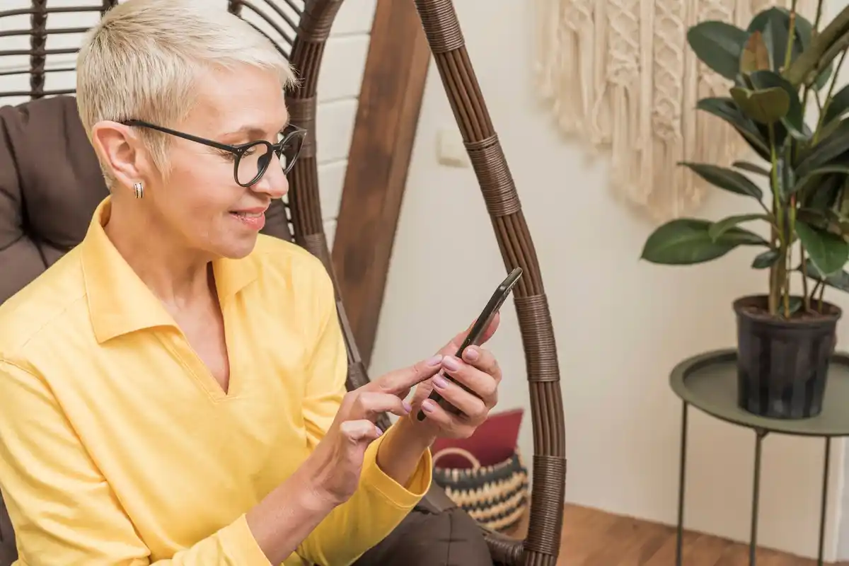 elderly person using bluetooth tracker at home