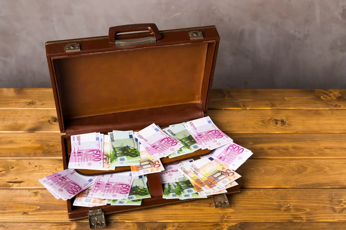 Dutch banknotes and coins scattered on a desk with a receipt