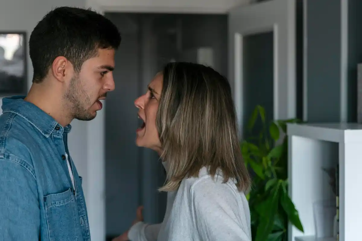 Dutch couple laughing after argument home interior