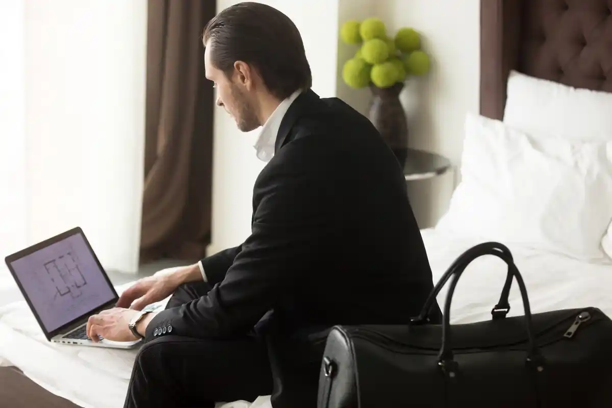 person happily booking hotel on laptop
