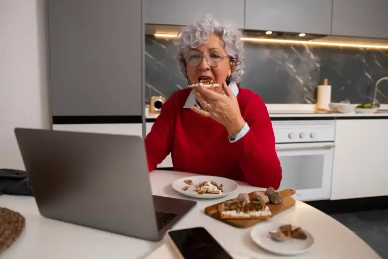Dutch grandmother cooking with modern airfryer kitchen