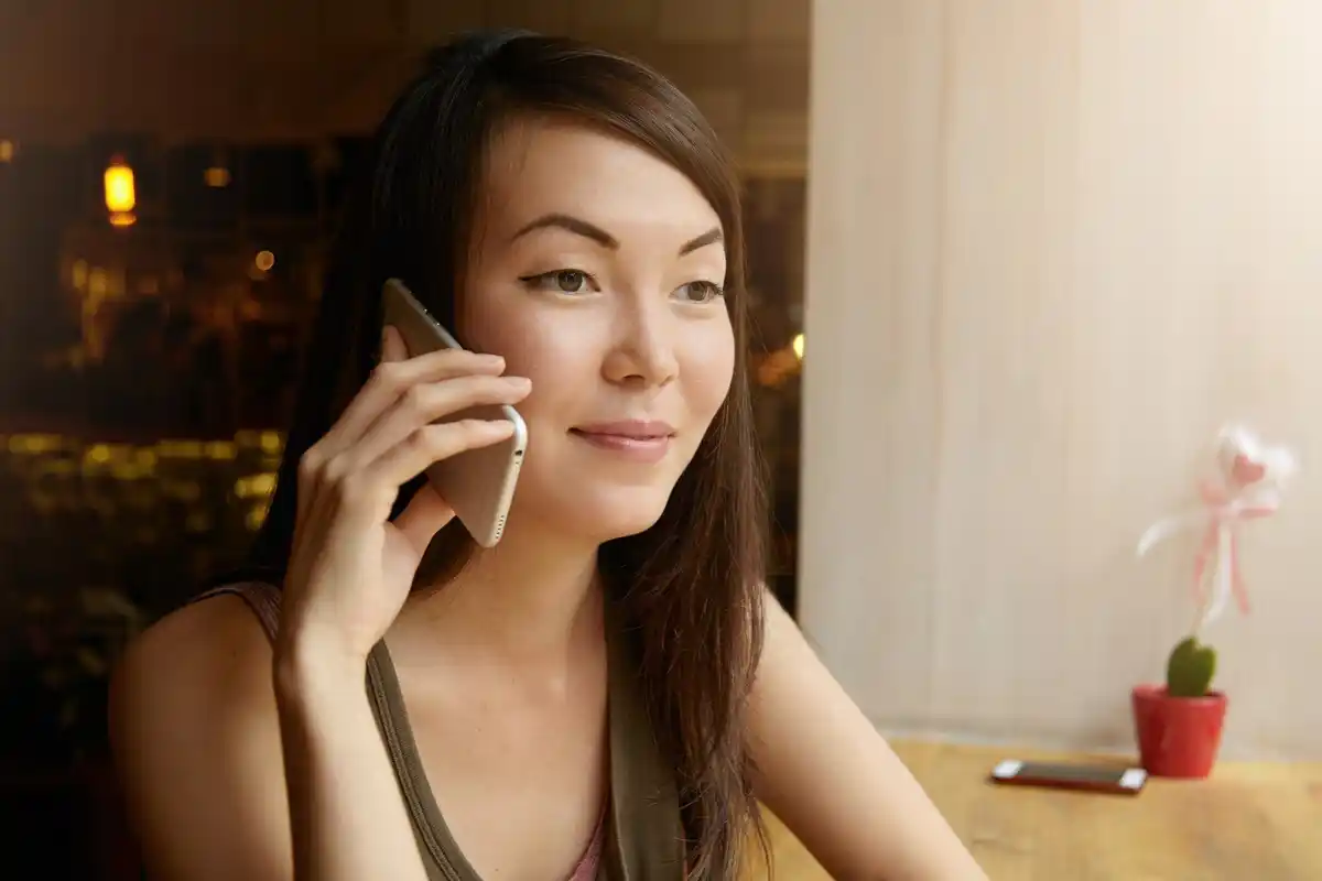 korean woman applying sunscreen bright morning home