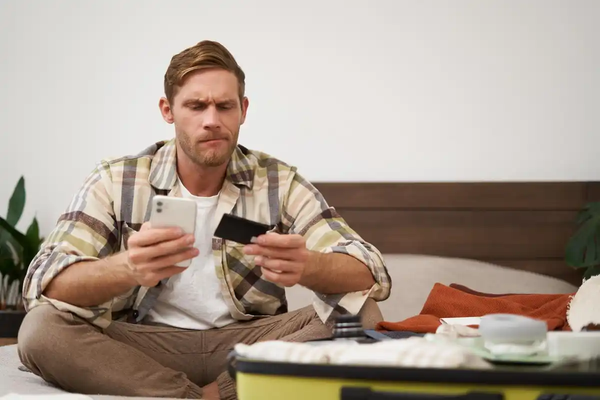 netherlands frustrated man checking bank app fees