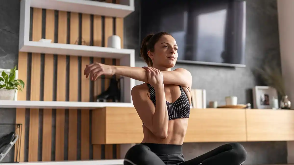Dutch person doing back stretching exercise at home