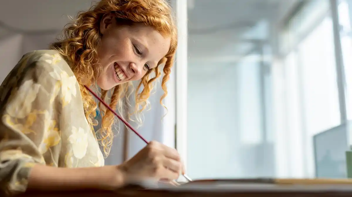 dutch student writing by hand at home