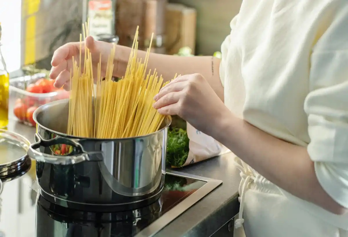 metal spoon in boiling water pasta kitchen