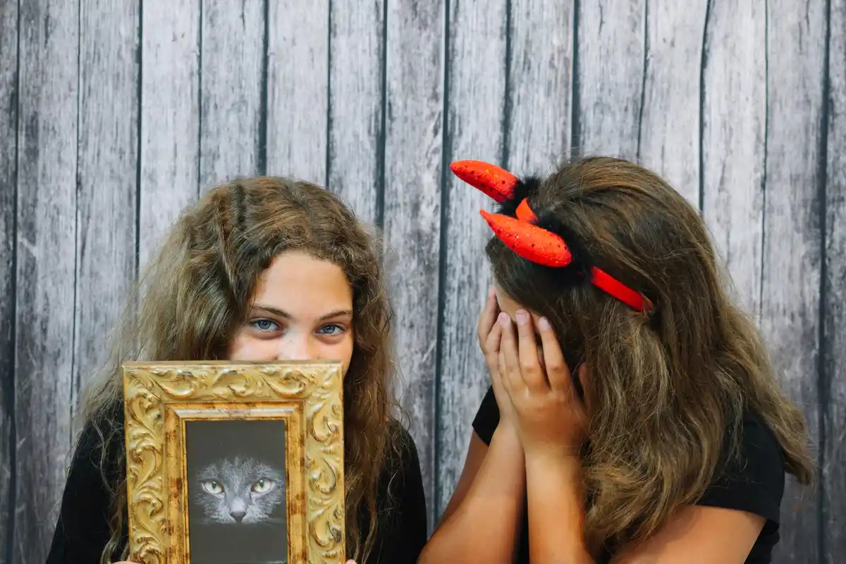 Dutch woman looking at her hair in the mirror, uncertain