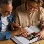 happy couple looking at old family photos at home