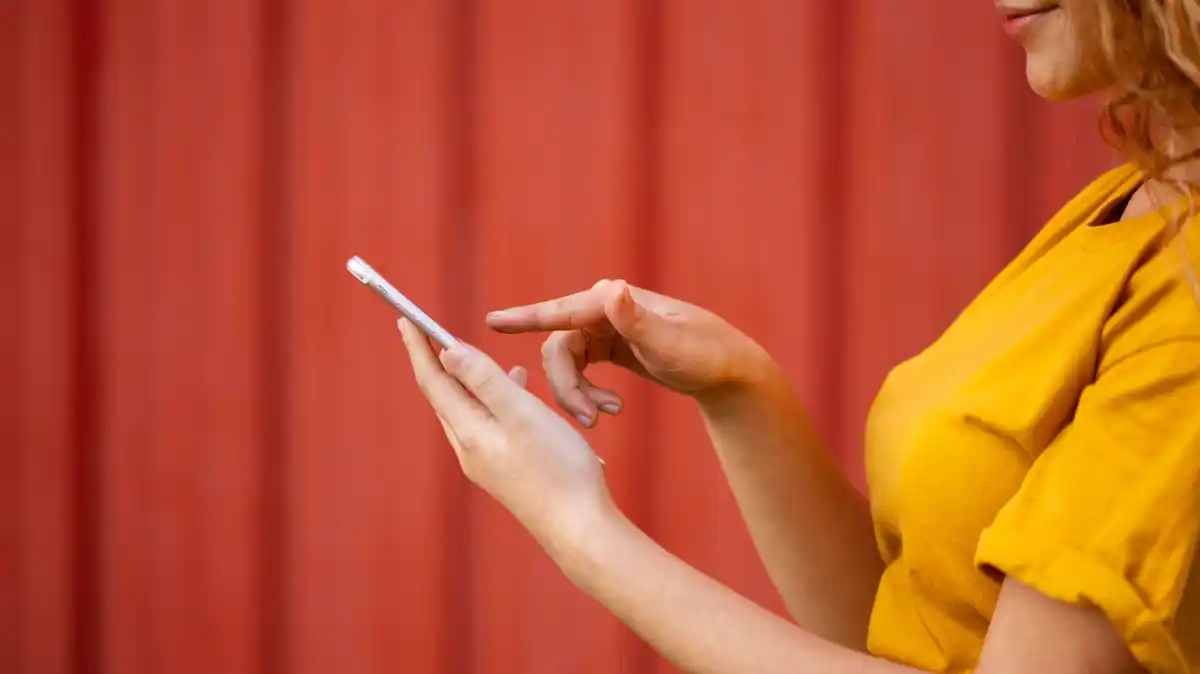 dutch woman turning off bluetooth on smartphone close up