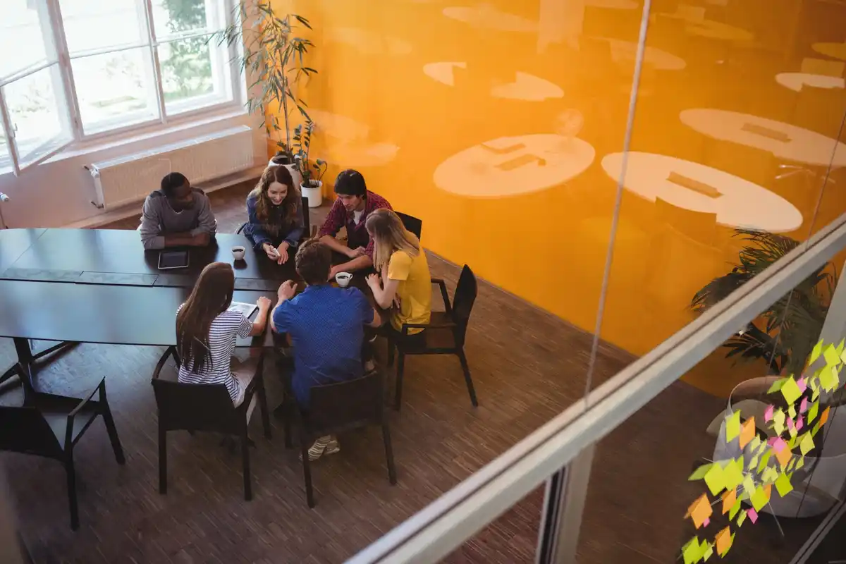 people having a spontaneous creative meeting in a bright Dutch office