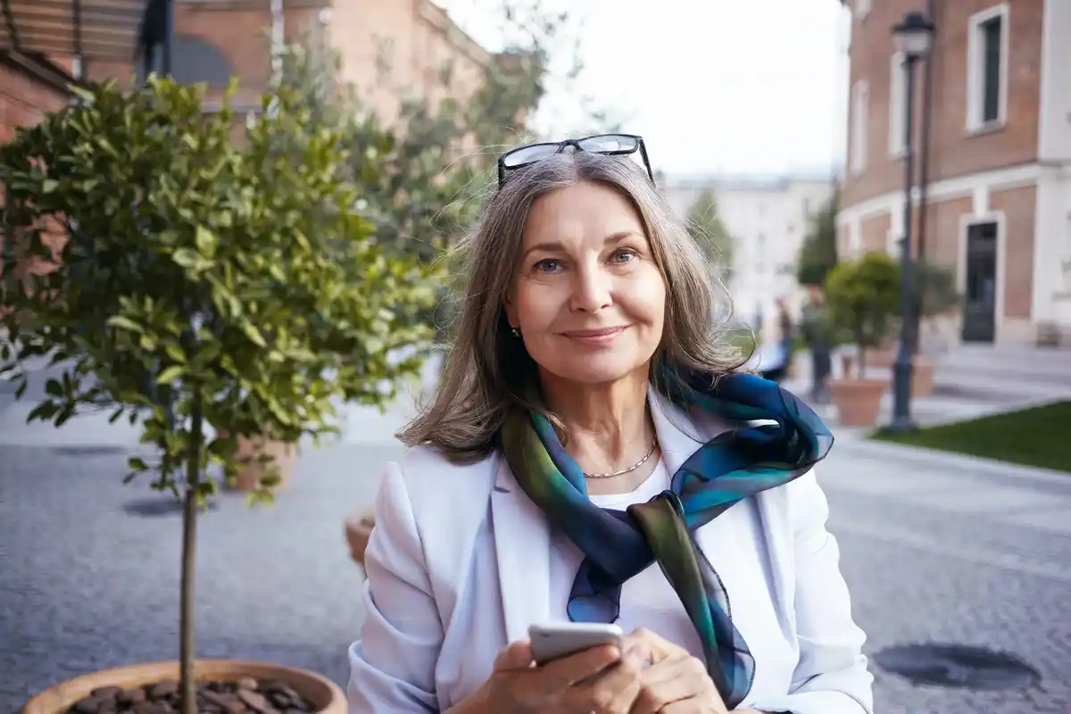 Dutch woman natural aging laughing outside sun - authentic lifestyle