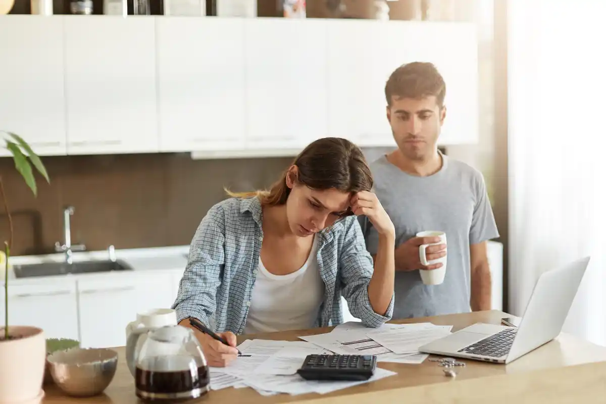 Dutch family checking energy bill at home, kitchen table, bills, worried