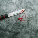 damaged chef knife on glass cutting board
