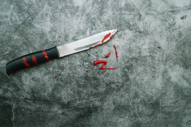 damaged chef knife on glass cutting board