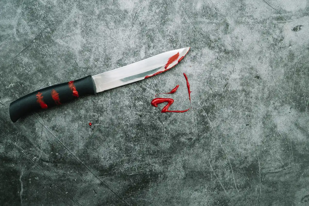 damaged chef knife on glass cutting board
