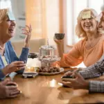 elderly Dutch friends laughing coffee park