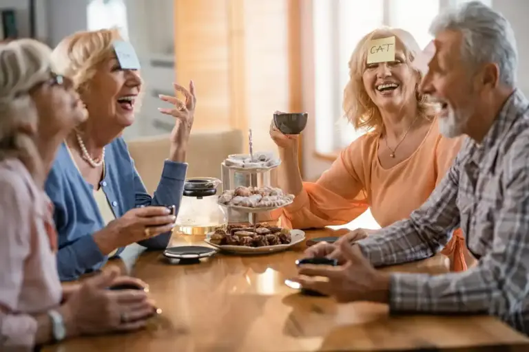 elderly Dutch friends laughing coffee park