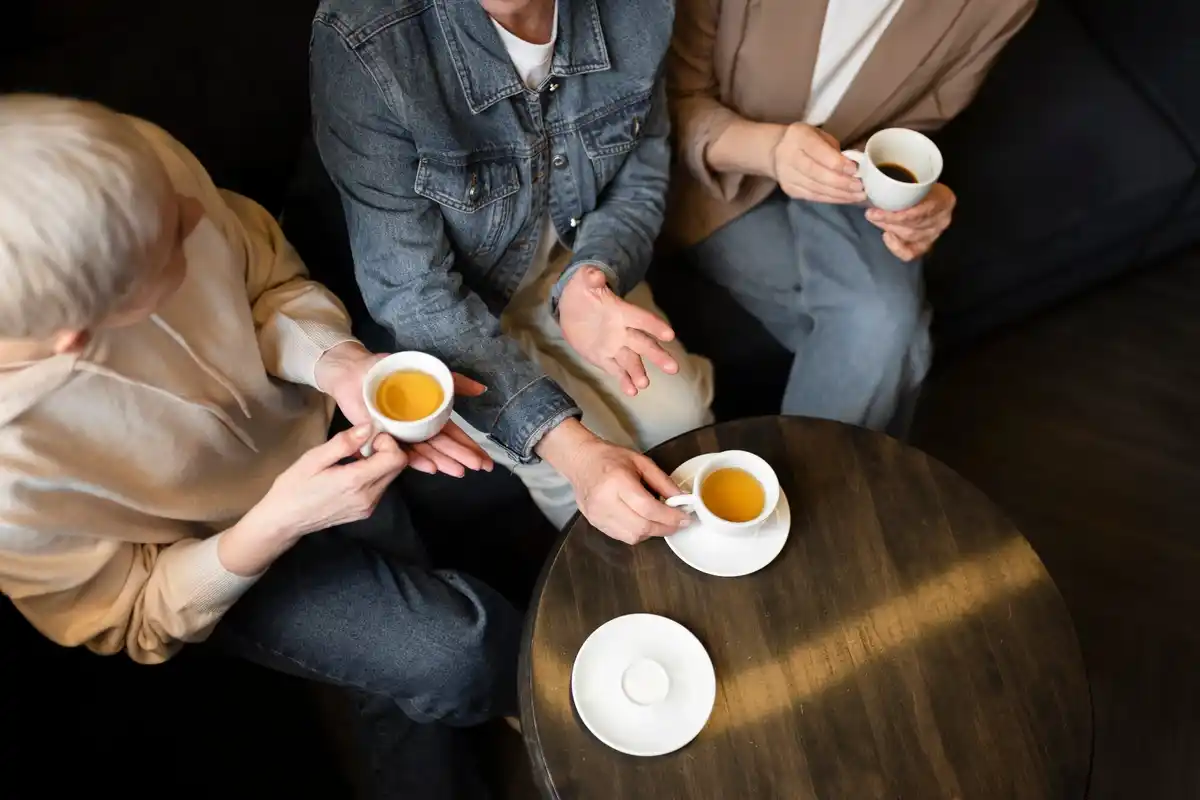 Dutch elderly friends drinking coffee together in a cozy cafe