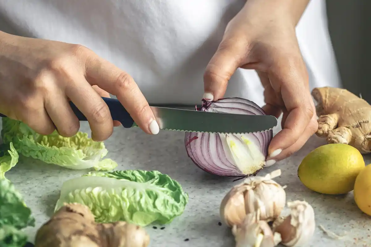 close up crying while cutting onion kitchen
