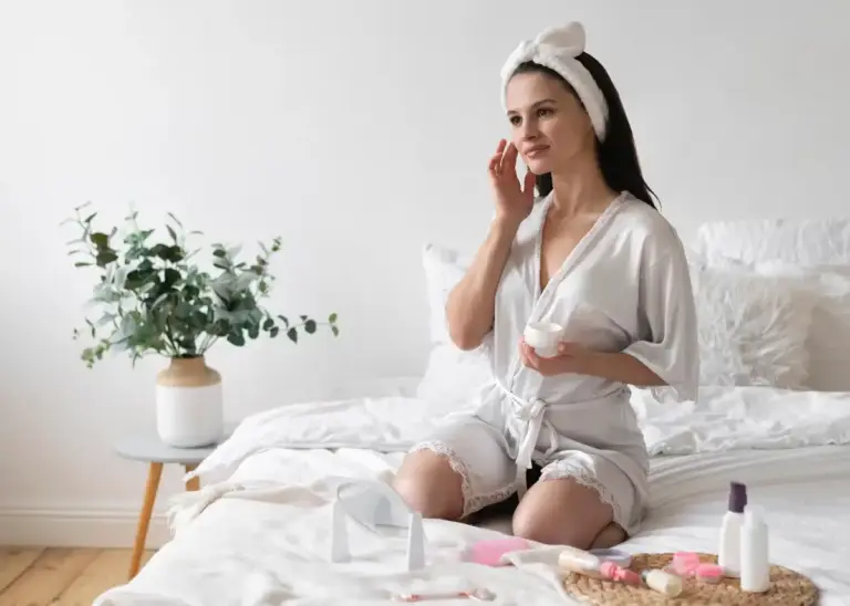 woman applying vaseline on face night routine dutch bedroom