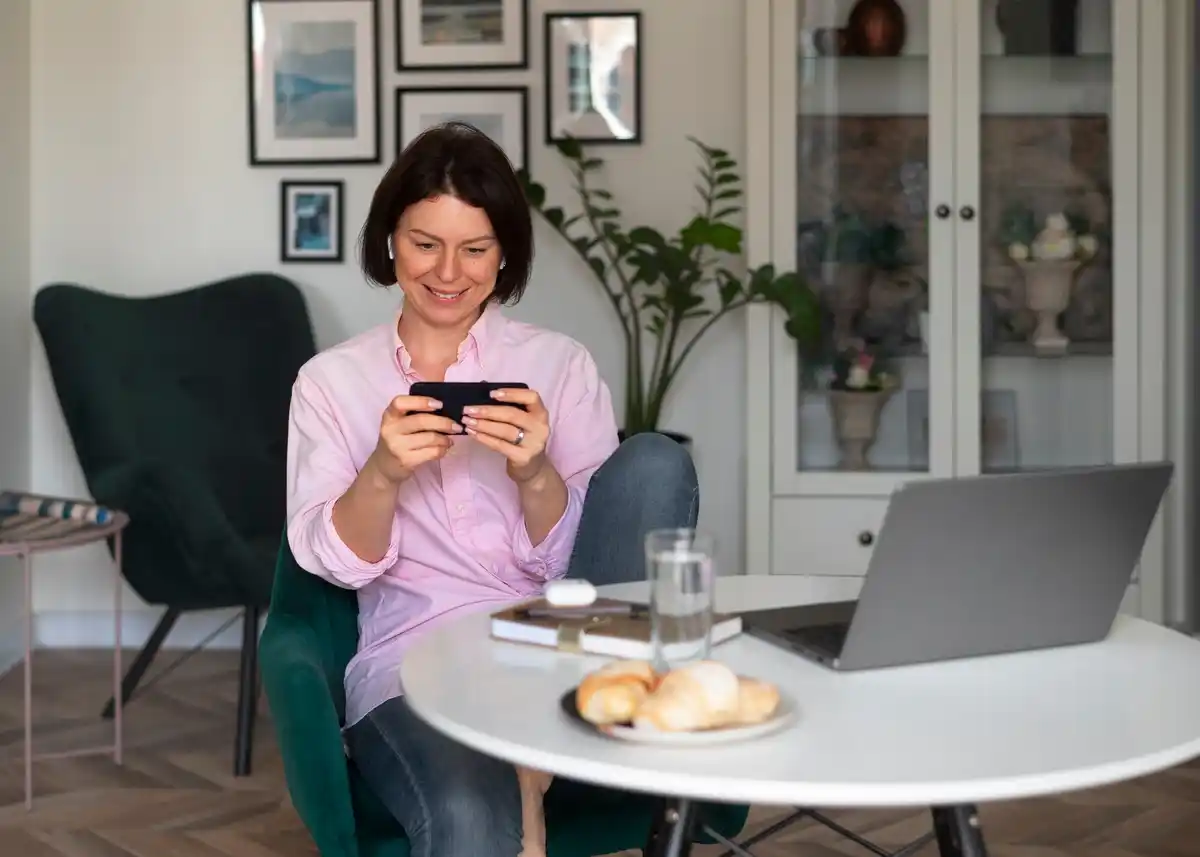 dutch person checking subscriptions on phone home table