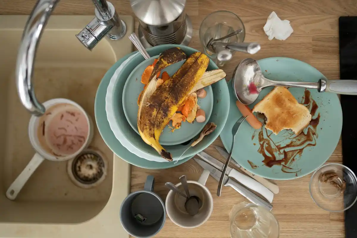 messy kitchen sink with coffee mug dutch home morning light