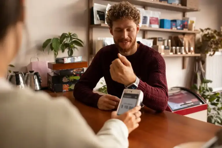 young Dutch people paying with smartphone QR code street cafe