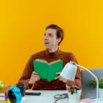 young Dutch student distracted multitasking studying table