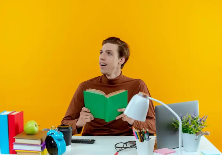young Dutch student distracted multitasking studying table