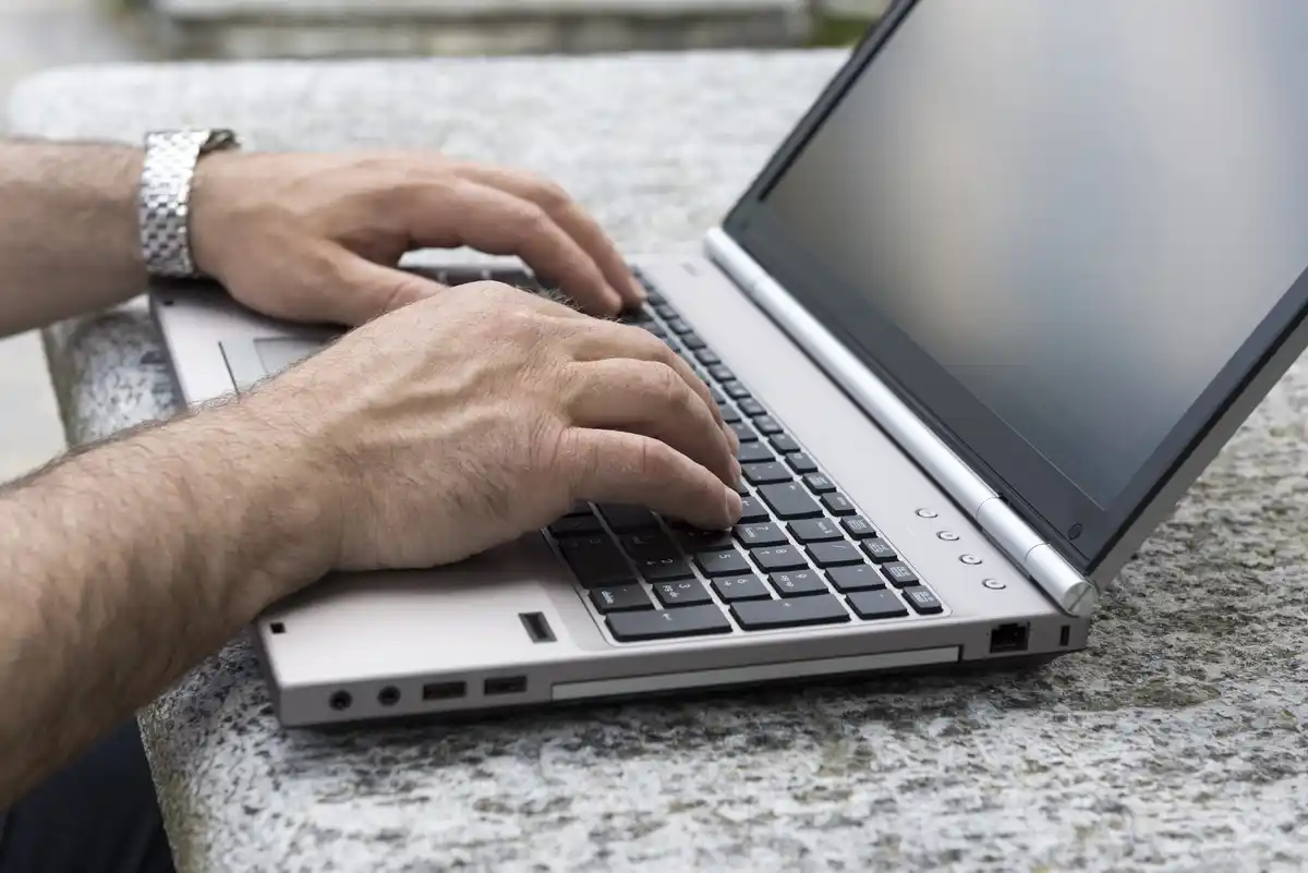 closeup hands pressing keyboard shortcuts on laptop netherlands