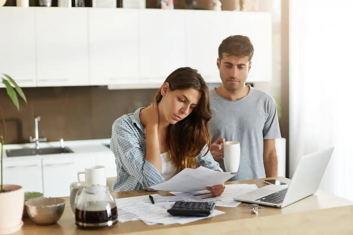 Dutch family calculating tax returns at kitchen table receipts