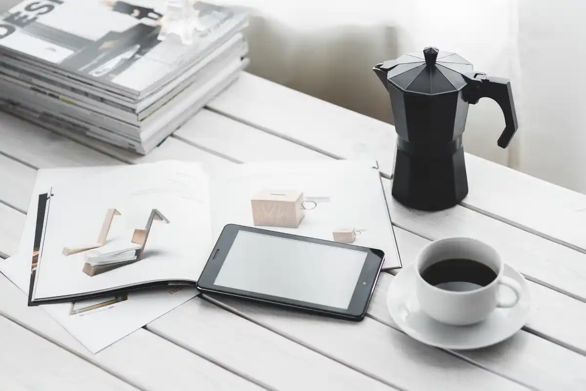 overloaded digital to do list on phone next to coffee