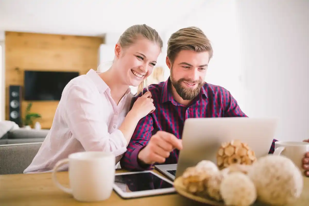 Dutch couple managing finances at home with coffee