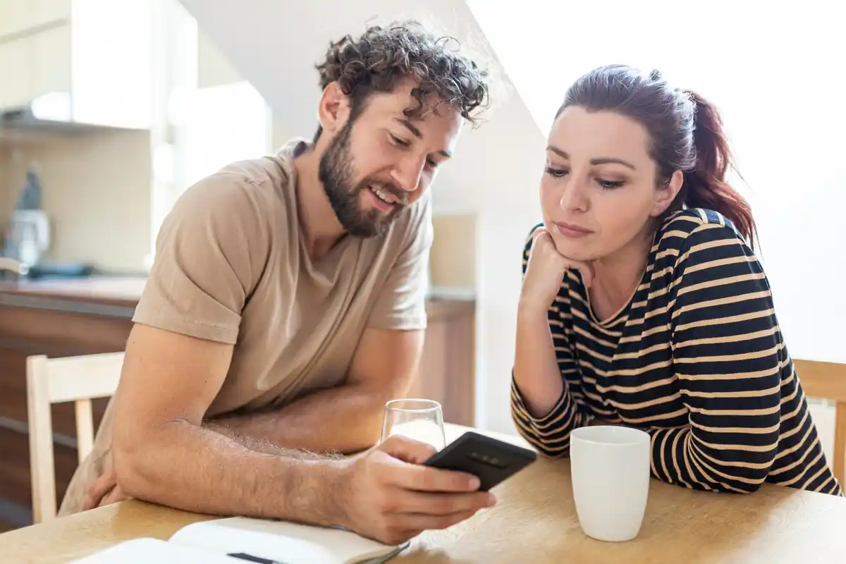 Dutch family checking personal finance app together