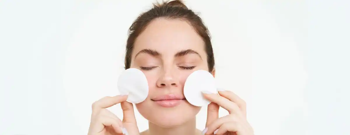 using toner with cotton pad vs hands skincare closeup