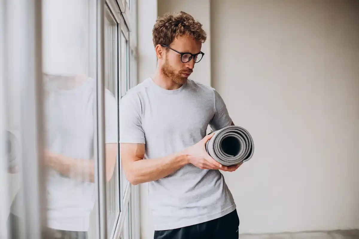 motivated middle-aged dutch man doing morning exercise at home living room sunlight