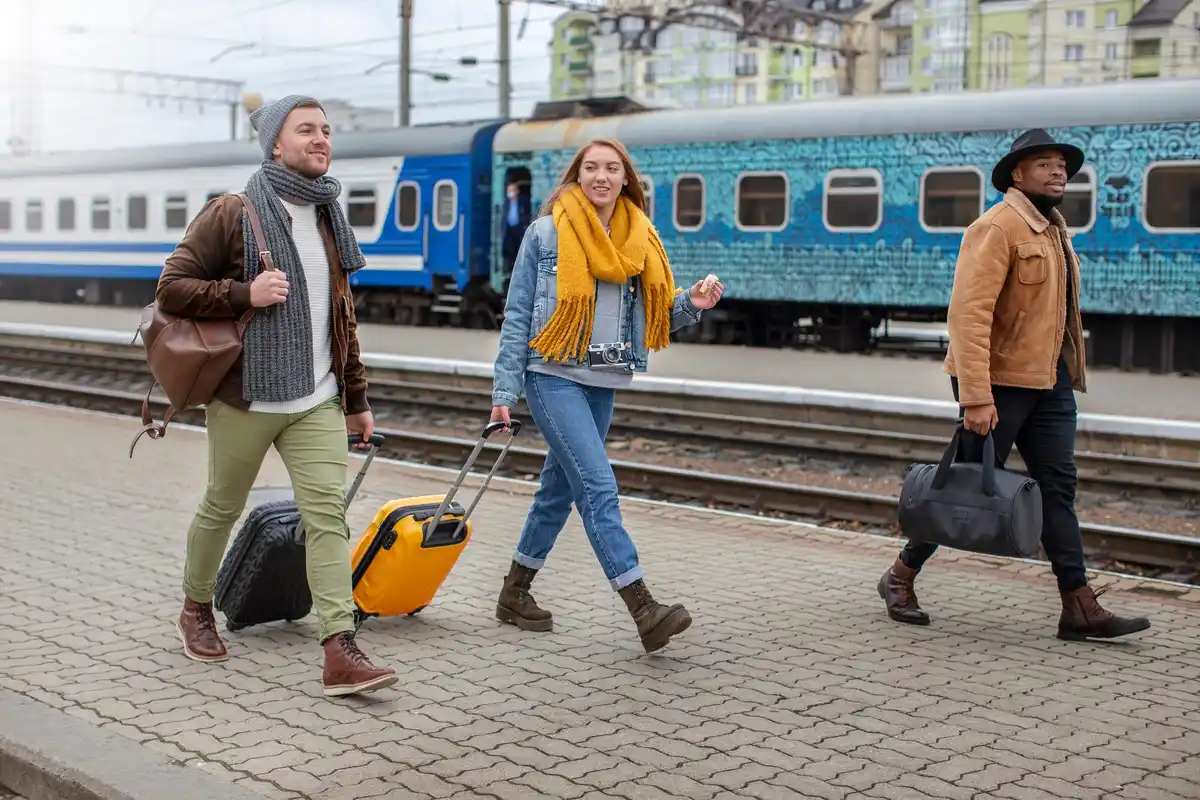 group of Dutch students smiling at train station with luggage