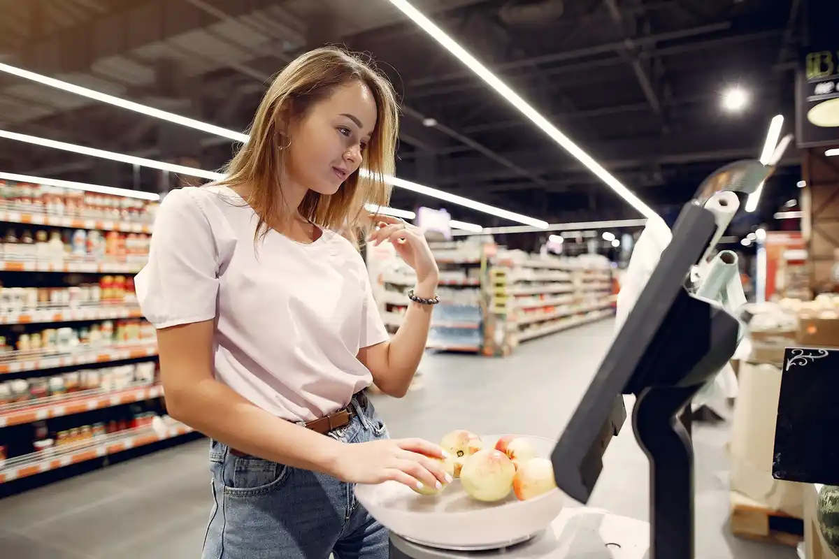 dutch woman counting coins at supermarket checkout