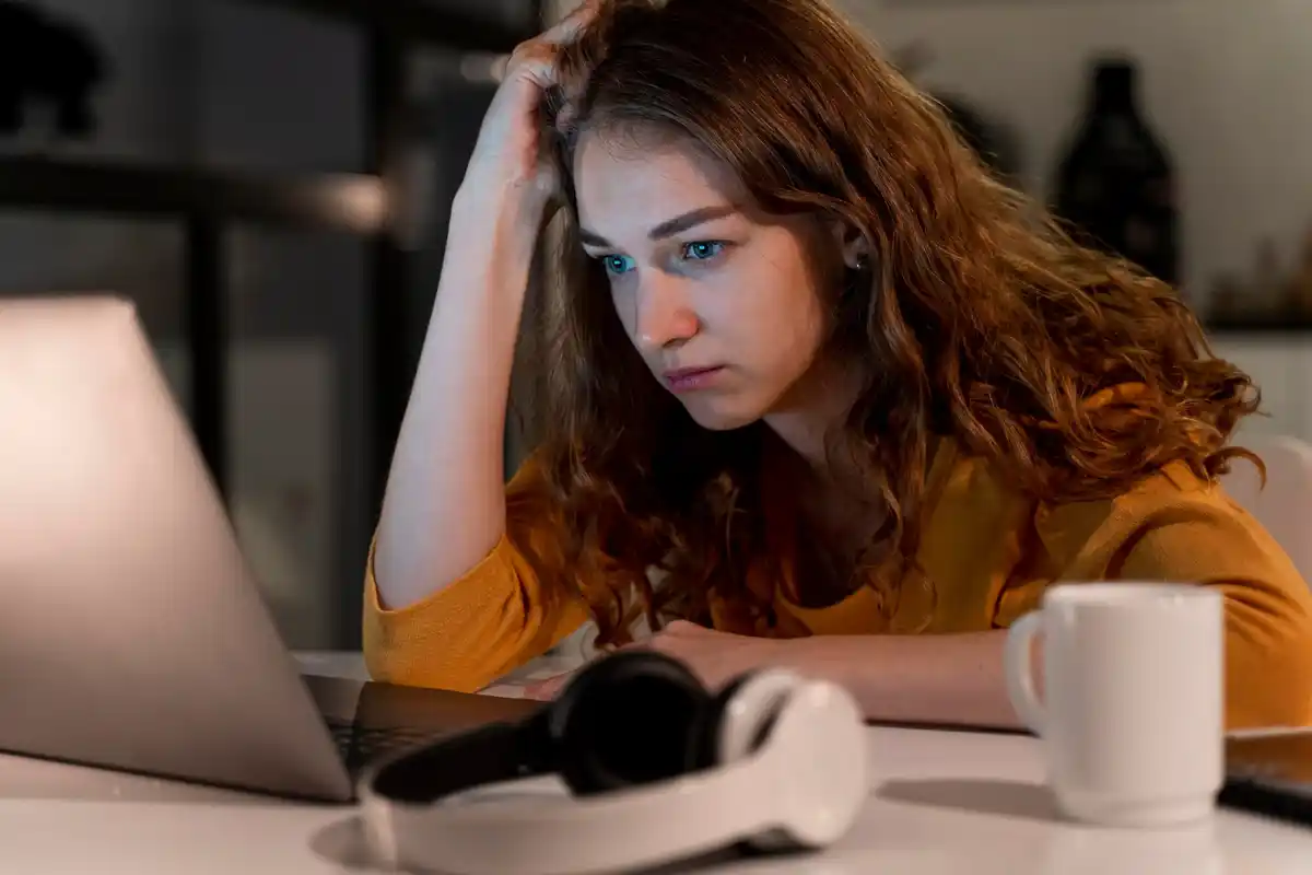 frustrated person looking at slow wifi on laptop