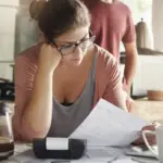 stressed Dutch person with tax documents at home