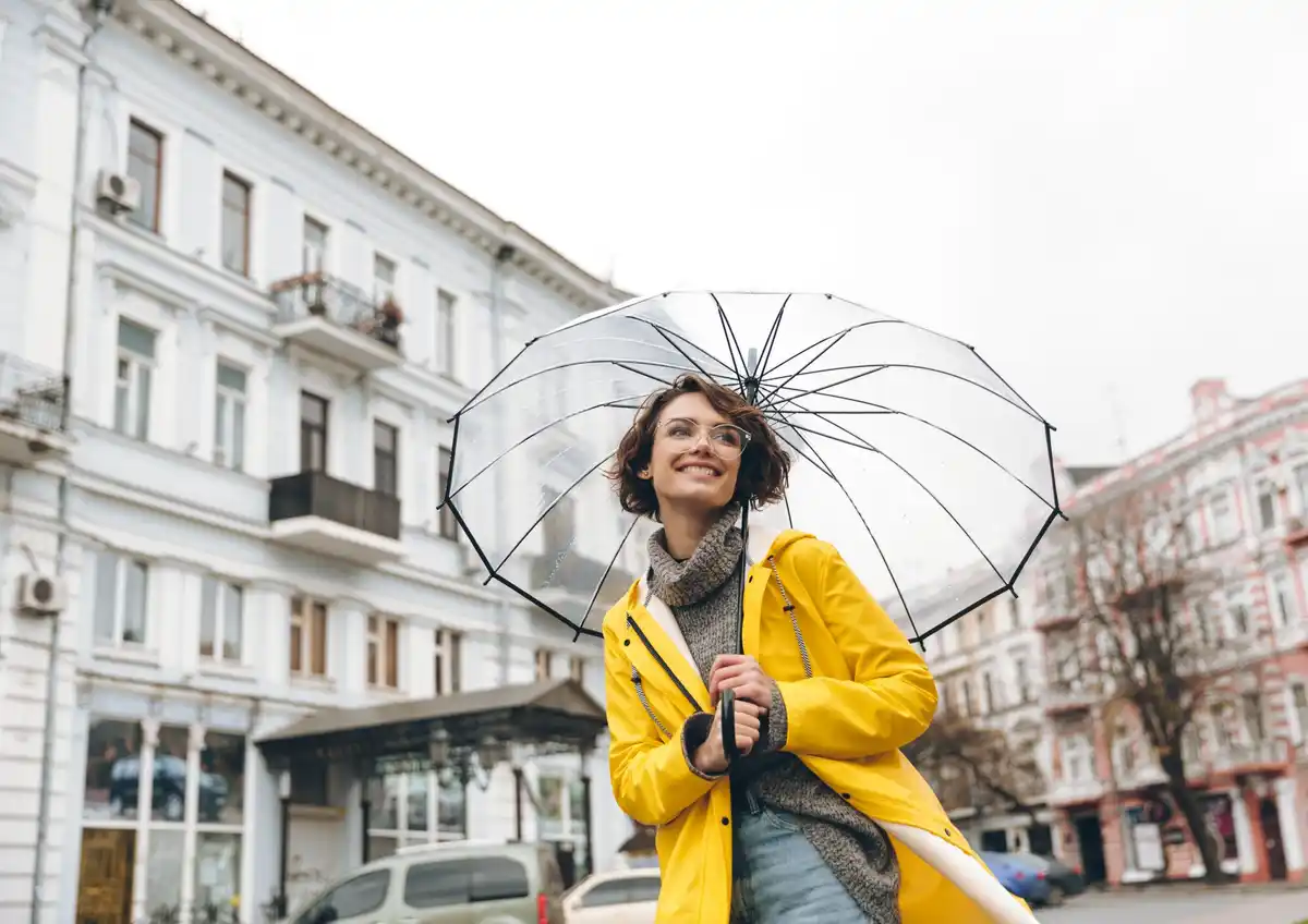dutch rainy day woman with umbrella makeup close up