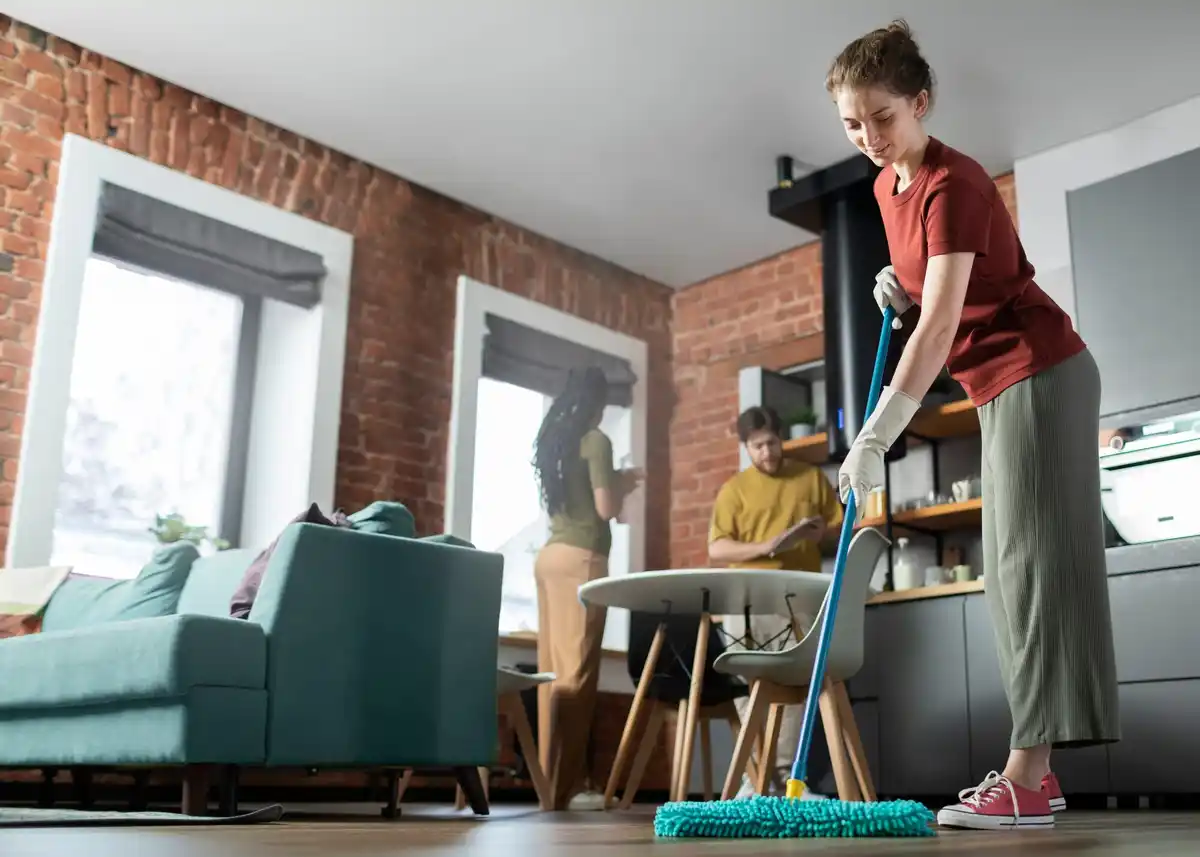 Dutch woman cleaning floor with spray mop at home modern interior
