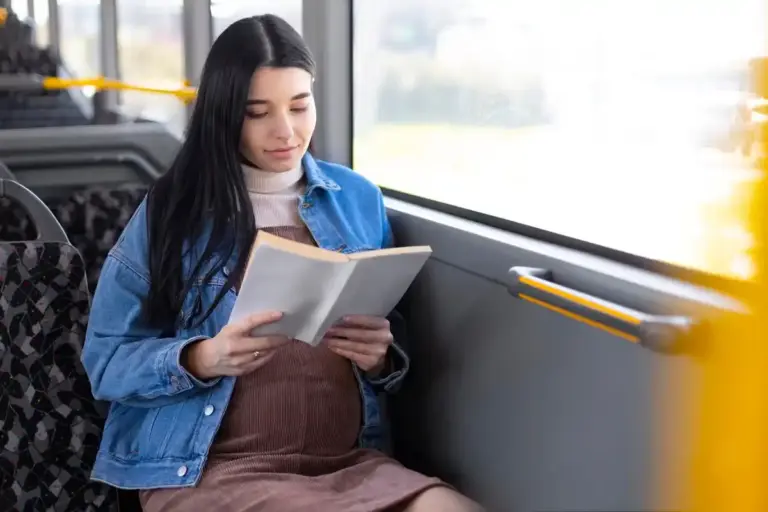dutch person reading book public transport