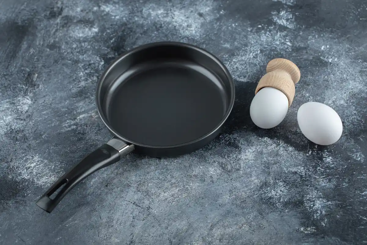 old frying pan with burnt food on Dutch kitchen table
